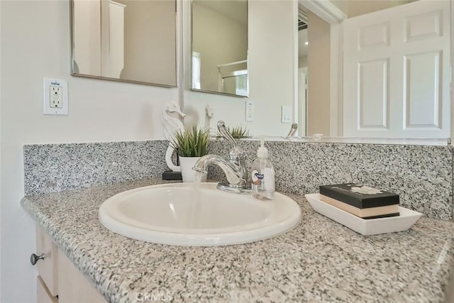 bathroom with tasteful backsplash and vanity