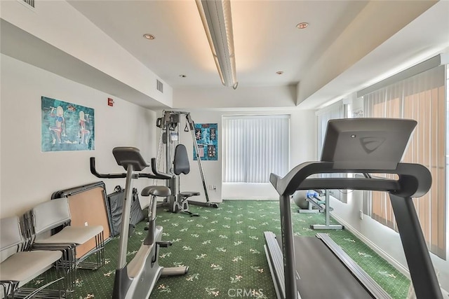 exercise room with carpet flooring and visible vents