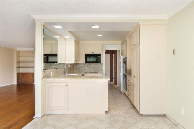 32709 Seagate Dr Unit 108, Rancho Palos Verdes, CA 90275 - kitchen featuring a peninsula, decorative backsplash, a sink, and black microwave