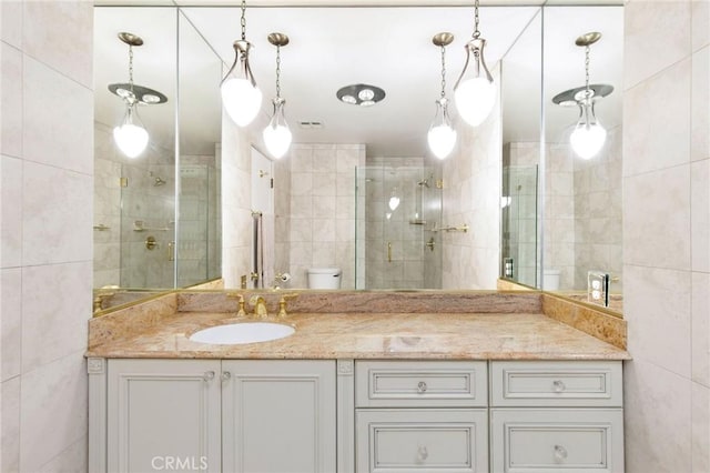 32709 Seagate Dr Unit 108, Rancho Palos Verdes, CA 90275 - bathroom featuring tile walls, vanity, toilet, and tiled shower