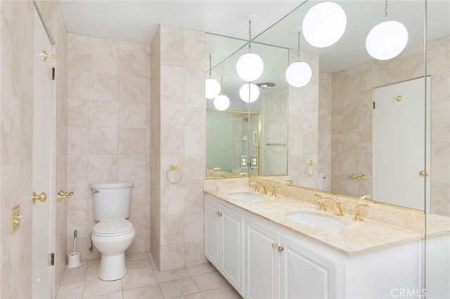 32709 Seagate Dr Unit 108, Rancho Palos Verdes, CA 90275 - bathroom featuring tile walls, tile patterned floors, double vanity, and a sink