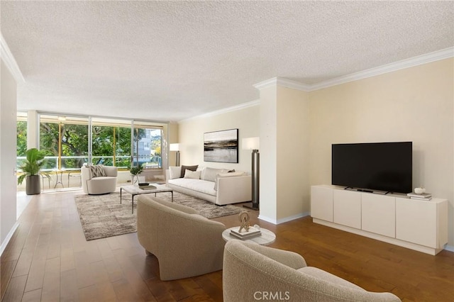 living room with crown molding, a textured ceiling, baseboards, and wood finished floors