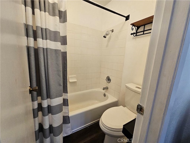 full bath featuring shower / tub combo with curtain and toilet