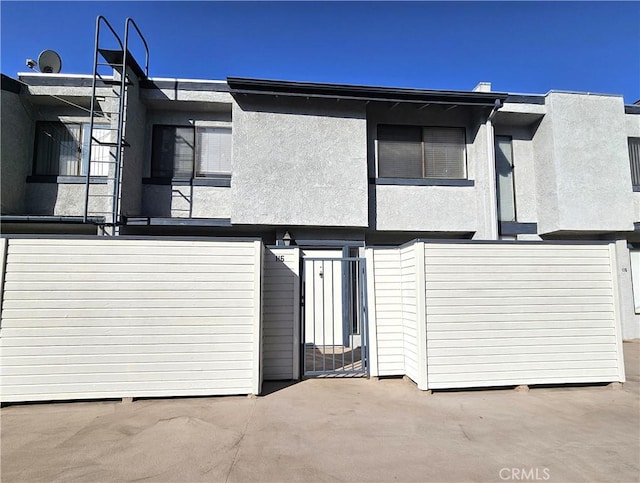 back of property featuring stucco siding