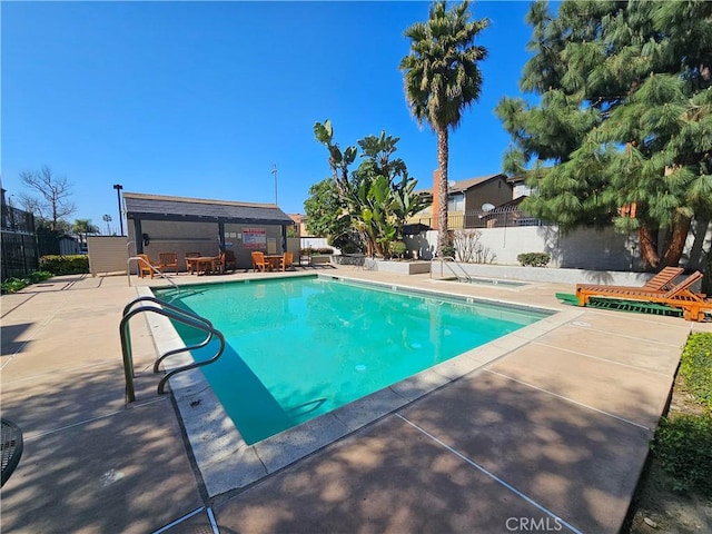 pool featuring a patio and fence