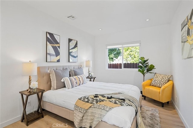 bedroom with light wood-style flooring, recessed lighting, visible vents, and baseboards