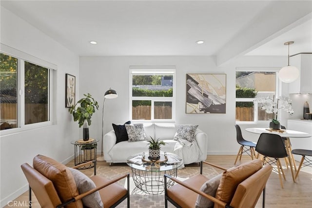 living area featuring light wood-style floors, baseboards, and recessed lighting