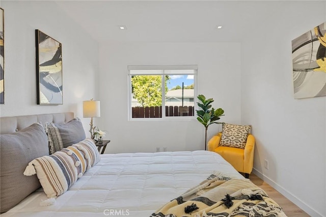 bedroom with baseboards and wood finished floors