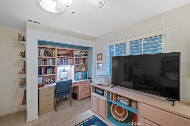 office area with light carpet, visible vents, and wallpapered walls