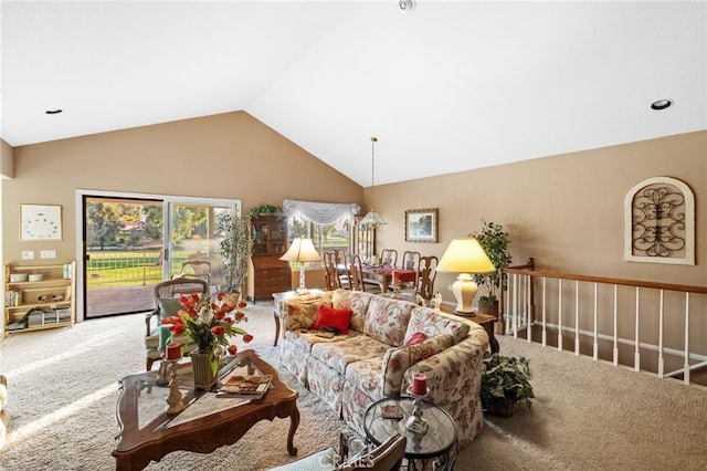 carpeted living area with vaulted ceiling