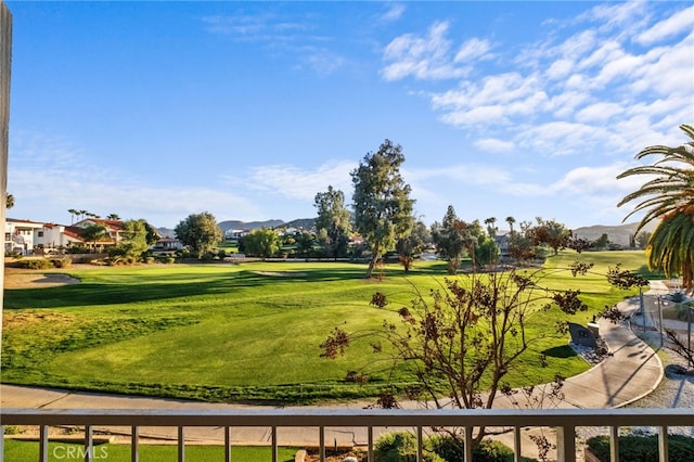 view of community with a lawn and a mountain view