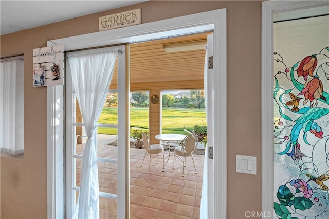 entryway with a sunroom and light tile patterned floors