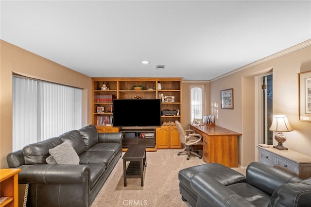 living area with light carpet, visible vents, and crown molding