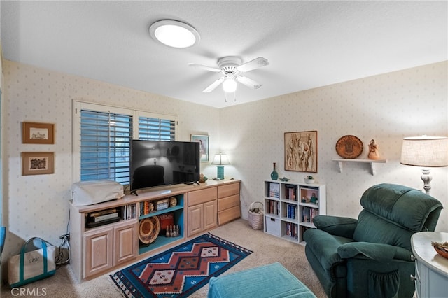 living room with light carpet, wallpapered walls, a textured ceiling, and a ceiling fan