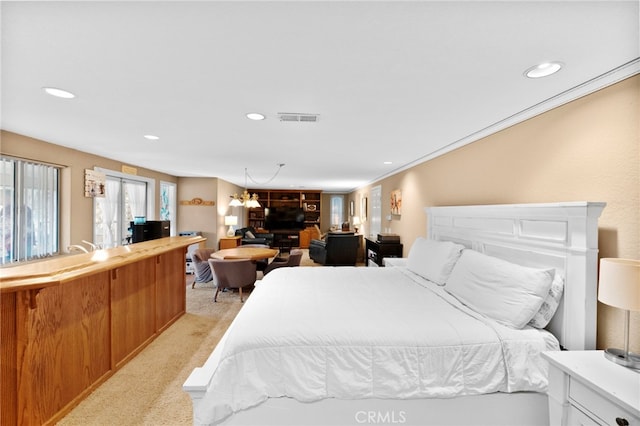 bedroom featuring a notable chandelier, light carpet, recessed lighting, visible vents, and crown molding