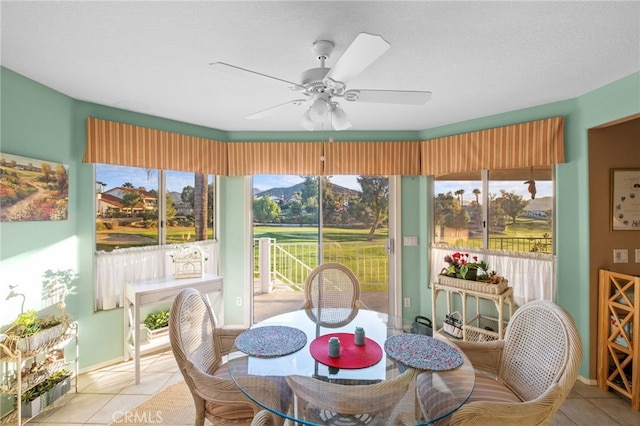 sunroom / solarium featuring a ceiling fan