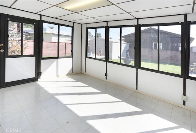 unfurnished sunroom featuring a paneled ceiling