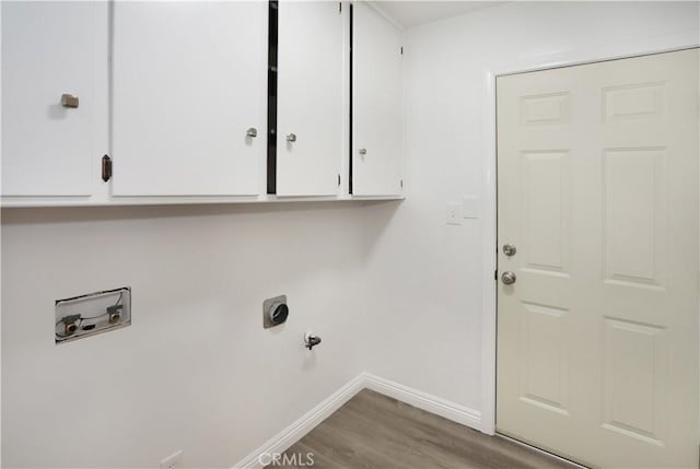 laundry area featuring gas dryer hookup, washer hookup, wood finished floors, baseboards, and cabinet space