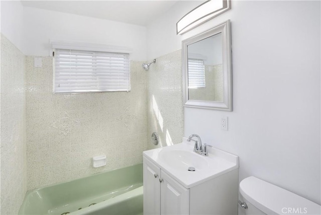 bathroom with toilet, washtub / shower combination, and vanity