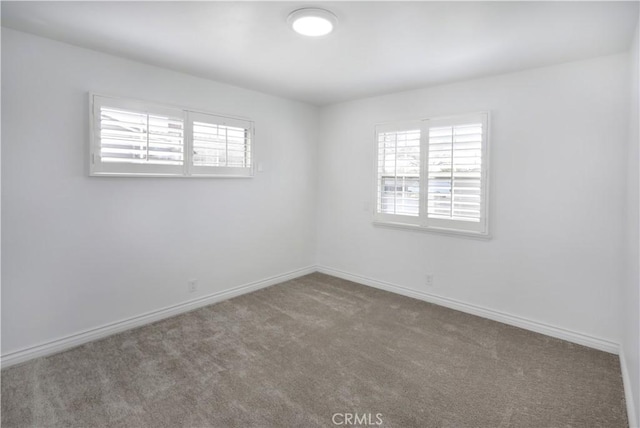 spare room with carpet flooring and baseboards