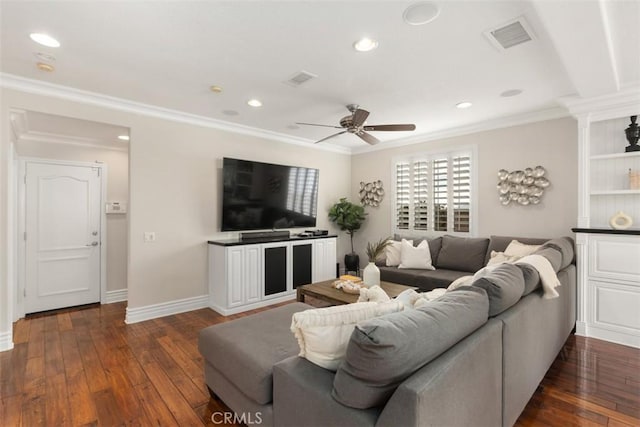 living area with baseboards, visible vents, dark wood finished floors, crown molding, and recessed lighting