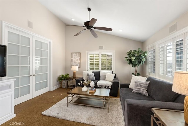 living area featuring a ceiling fan, dark colored carpet, visible vents, and lofted ceiling