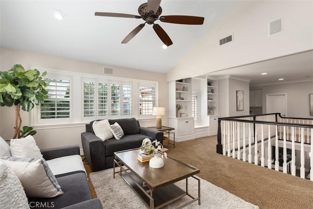 living room featuring built in shelves, visible vents, and light carpet