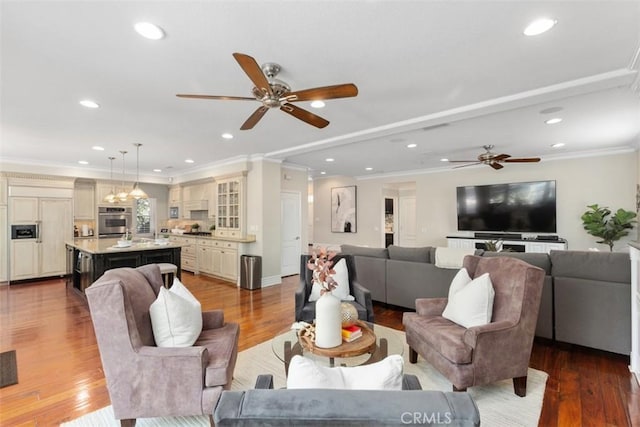 living room featuring ornamental molding, recessed lighting, and wood finished floors