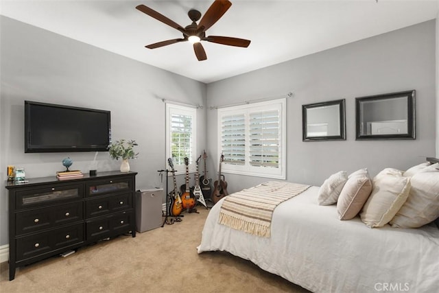 bedroom with a ceiling fan and light colored carpet