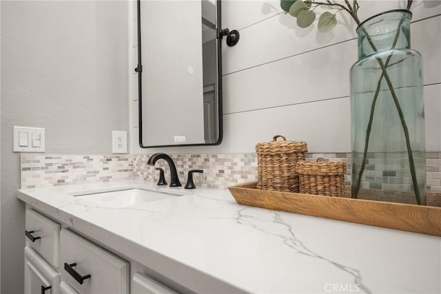 bathroom featuring tasteful backsplash and vanity