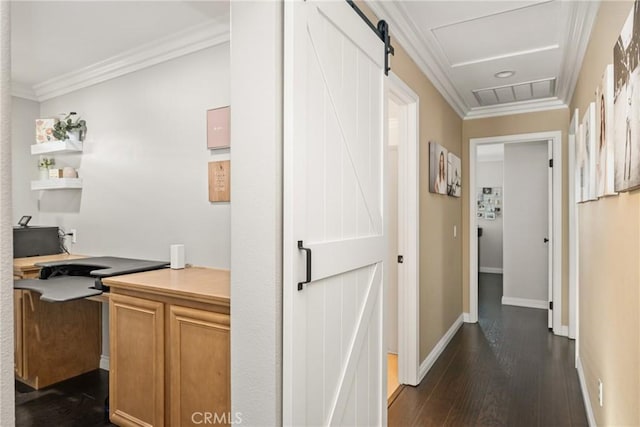 corridor featuring a barn door, visible vents, baseboards, ornamental molding, and dark wood finished floors