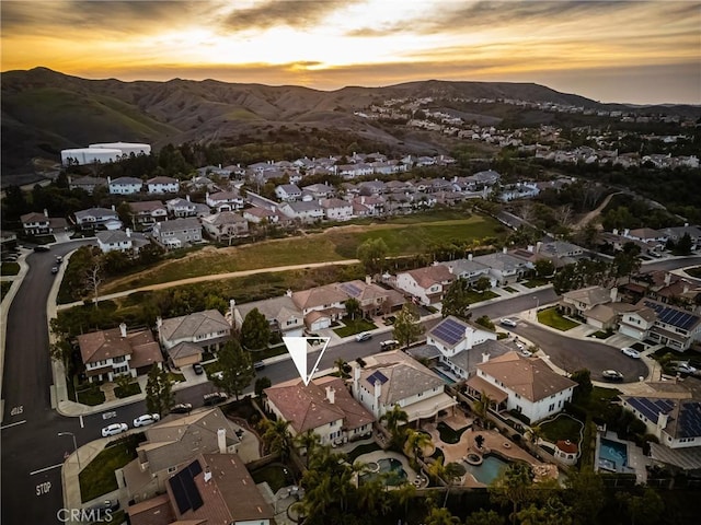 aerial view at dusk with a residential view and a mountain view