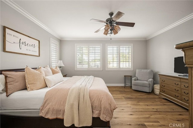 bedroom with light wood-style floors, baseboards, ornamental molding, and a ceiling fan