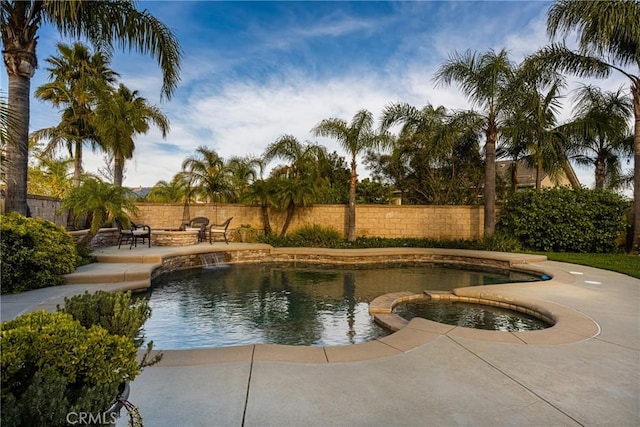 view of swimming pool with an in ground hot tub, a patio, fence private yard, and a fenced in pool