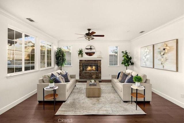 living area with dark wood-type flooring, visible vents, and crown molding