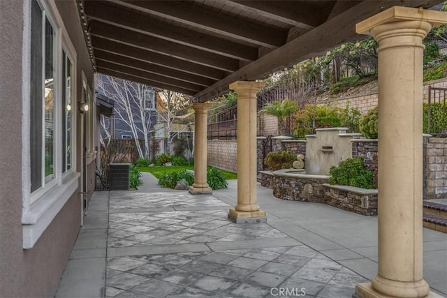 view of patio featuring fence