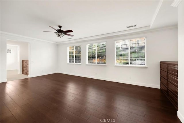 empty room with visible vents, dark wood-style flooring, and crown molding