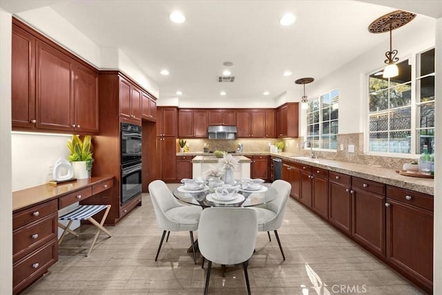 kitchen featuring dobule oven black, visible vents, hanging light fixtures, a sink, and exhaust hood