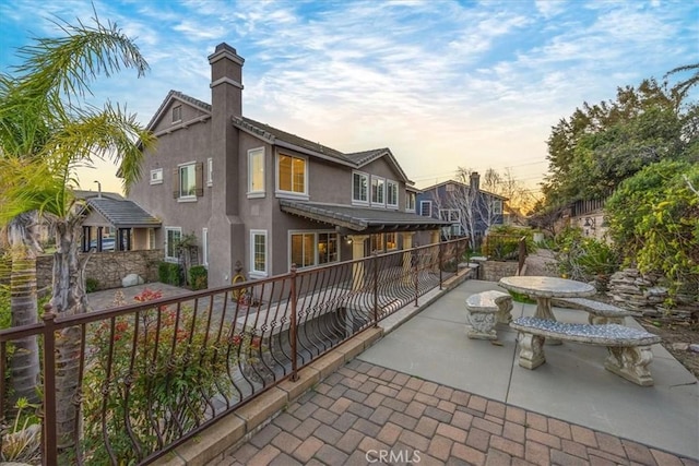 view of home's community with a patio area