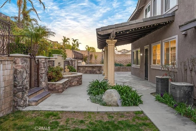 view of patio with fence and central AC