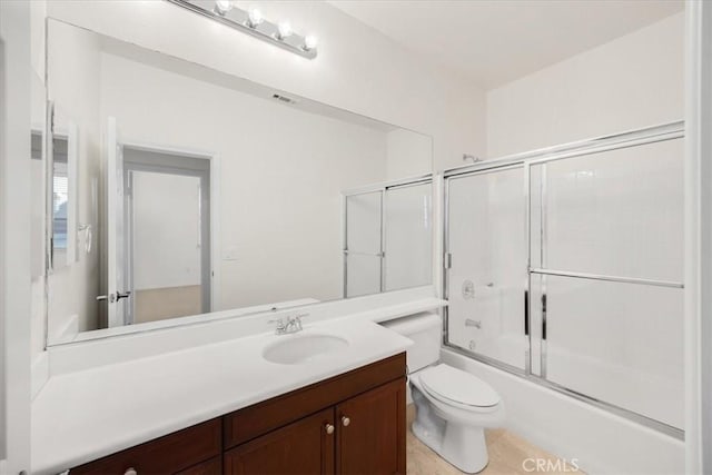 full bathroom featuring toilet, visible vents, combined bath / shower with glass door, and vanity