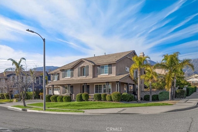 view of front of property with a front lawn and stucco siding