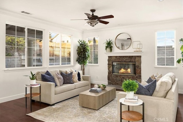 living area featuring ornamental molding, plenty of natural light, wood finished floors, and baseboards