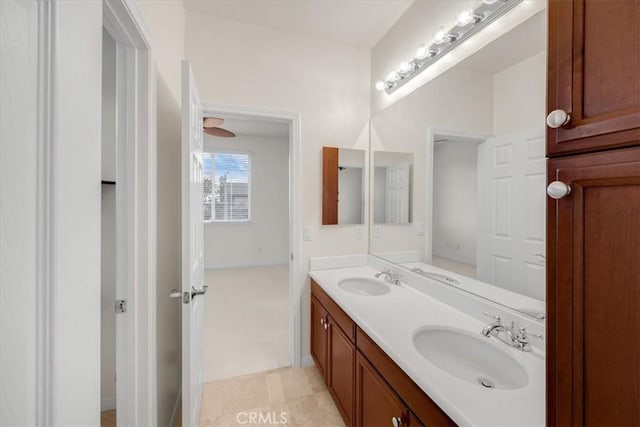 bathroom featuring tile patterned flooring, a sink, and double vanity