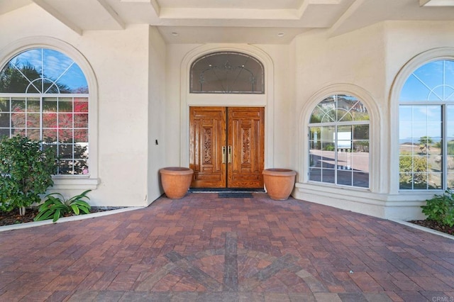 property entrance featuring stucco siding