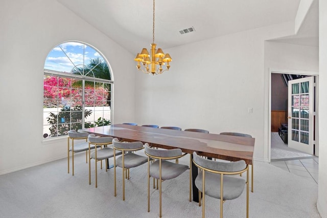 dining room with baseboards, visible vents, light colored carpet, lofted ceiling, and a chandelier