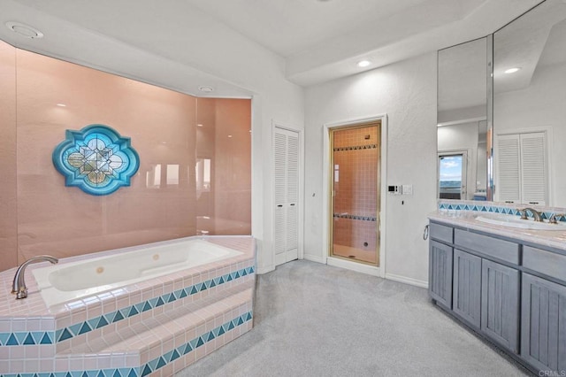 full bathroom with a closet, vanity, baseboards, and a bath