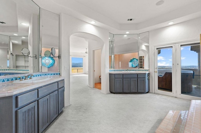 full bath with two vanities, recessed lighting, visible vents, and a sink