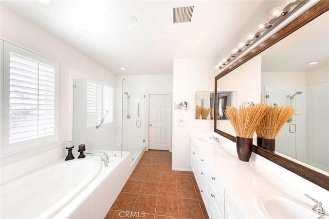 bathroom featuring a stall shower, visible vents, a sink, and a bath