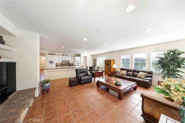 tiled living area featuring recessed lighting